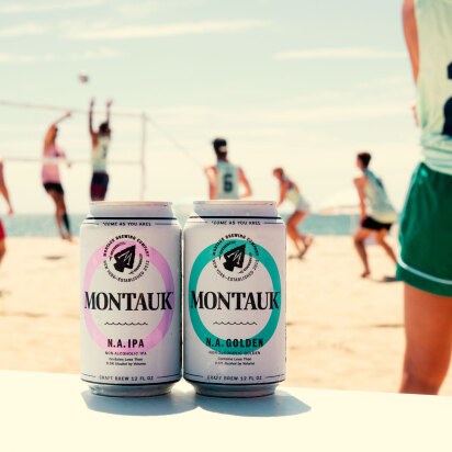 Montauk Brewing Co Non Alcoholic beers on the beach with volleyball in the background